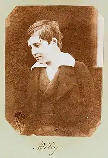 A photograph of Welsh boy, William Mansel (1838-1866) titled 'Willy', smiling at something off camera. Taken c. 1853, it is the earliest known photograph of a smile