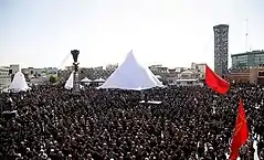 A crowd of mourning men in black clothing