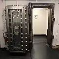 The first floor retail tenants share a men's restroom which was converted from the former bank vault, still with the vault door.