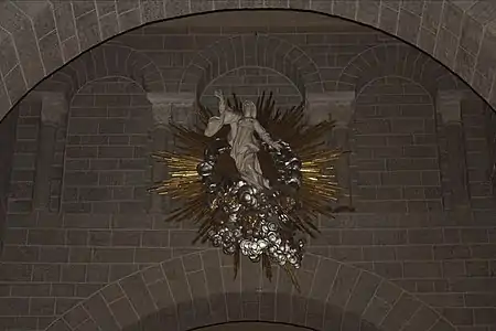 Assumption of the Virgin sculpture, painted wood, by Pierre Vaneau (17th c.)  on an arch over  the nave