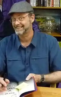 Moore signing a copy of Bite Me at Politics & Prose in Washington, 2010