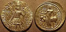 Coin of the Kushan king Kanishka II with, on the reverse, a depiction of Oesho and the word "Oesho" in modified Greek script.