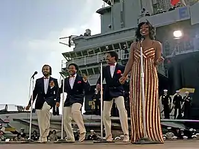 Gladys Knight & The Pips perform aboard the aircraft carrier USS&nbsp;Ranger on November 1, 1981. Left to right: William Guest, Edward Patten, Merald "Bubba" Knight, and Gladys Knight.