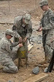 A 40&nbsp;lb (18&nbsp;kg) shaped charge munition (marked to indicate a Composition B filling) used for various demolition purposes such as boring a hole for a cratering charge.