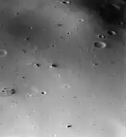 The surface of Deimos, a moon of Mars, is covered by a layer of regolith estimated to be 50&nbsp;m (160&nbsp;ft) thick. Viking 2 orbiter image is from a height of 30&nbsp;km (19&nbsp;mi).
