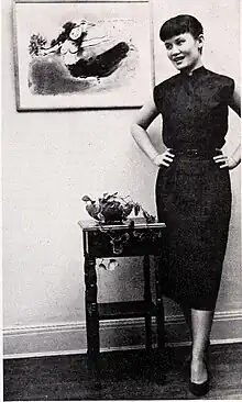 Chang beside a Marc Chagall lithograph, c. 1951