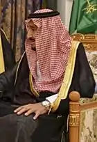 Image 25Red and white keffiyeh commonly worn in the desert held with a black agal (from Culture of Saudi Arabia)