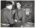 Major General Leland S. Hobbs presents the Legion Of Merit to Brigadier General James M. Lewis, commander of the 30th Division Artillery, for his meritorious service from July 28 to October 13, 1944.