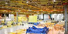 Space Launch System inter-tank section moving down the factory floor to the South VAB for vertical testing