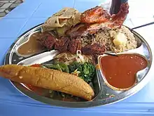 Image 31Traditional Tanzanian food consisting of pilau kuku (seasoned rice with chicken), mishkaki (grilled meat), ndizi (plantain), maharage (beans), mboga (vegetables), chapati (flatbread) and pili pili (hot sauce) (from Culture of Tanzania)
