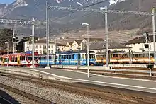 Train station Aigle with trains of AOMC, ASD und AL (from left to right)