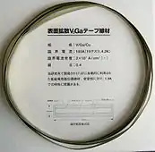 V3Ga superconducting tape (10×0.14&nbsp;mm cross section). A vanadium core is covered with 15&nbsp;µm V3Ga layer, then 20&nbsp;µm bronze (stabilizing layer) and 15&nbsp;µm insulating layer. Critical current 180&nbsp;A (19.2 tesla, 4.2&nbsp;K), critical current density 20&nbsp;kA/cm2
